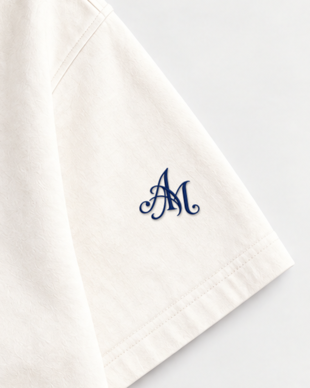 Close-up of the AM monogram on the left sleeve