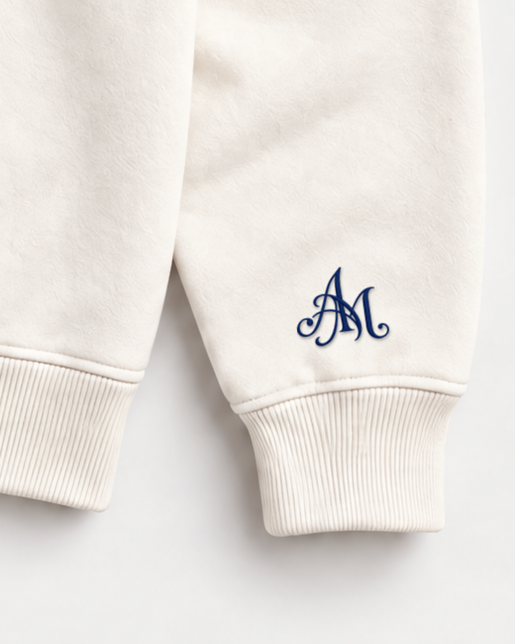 Close-up of the AM monogram on the left sleeve